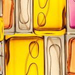 Top view, flat lay of a set of perfume bottles on a colorful background